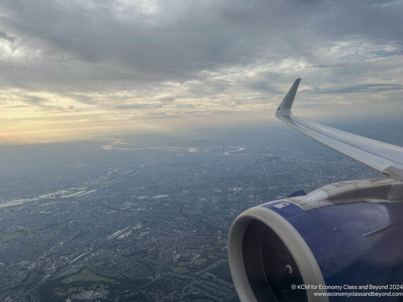 an airplane wing and a city