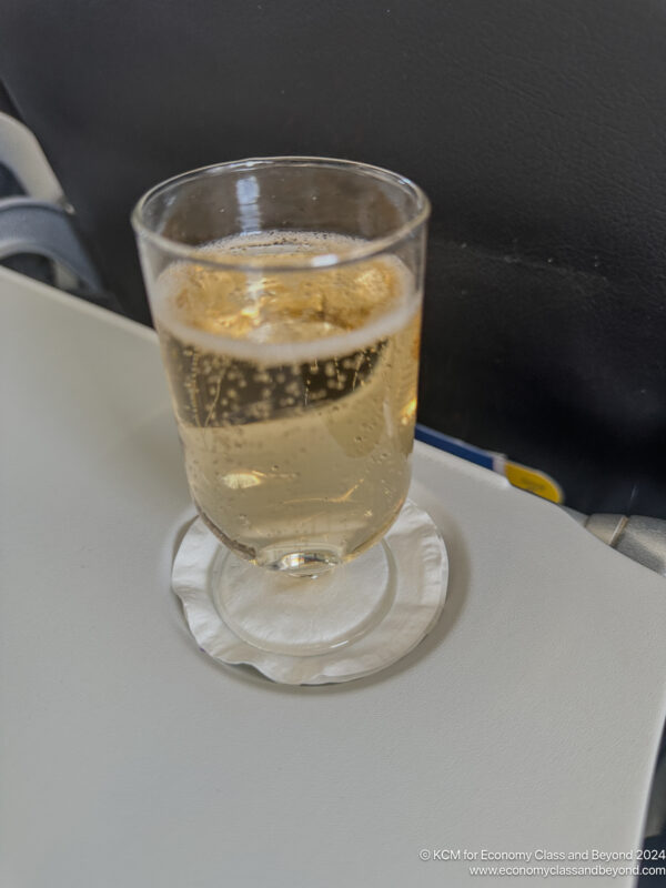 a glass of liquid on a coaster