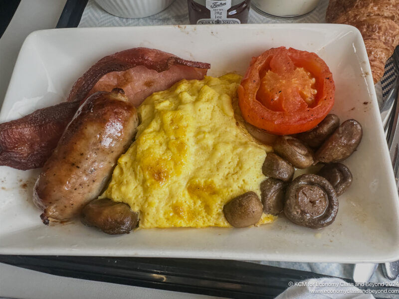 a plate of food with sausages and eggs