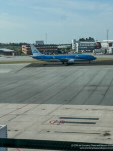 a blue airplane on a runway