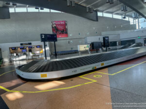 a baggage claim area with a conveyor belt