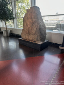 a large rock on a display in a room with a window
