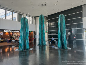 a group of tall blue sculptures in a building