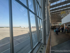 a large window with people walking on the ground