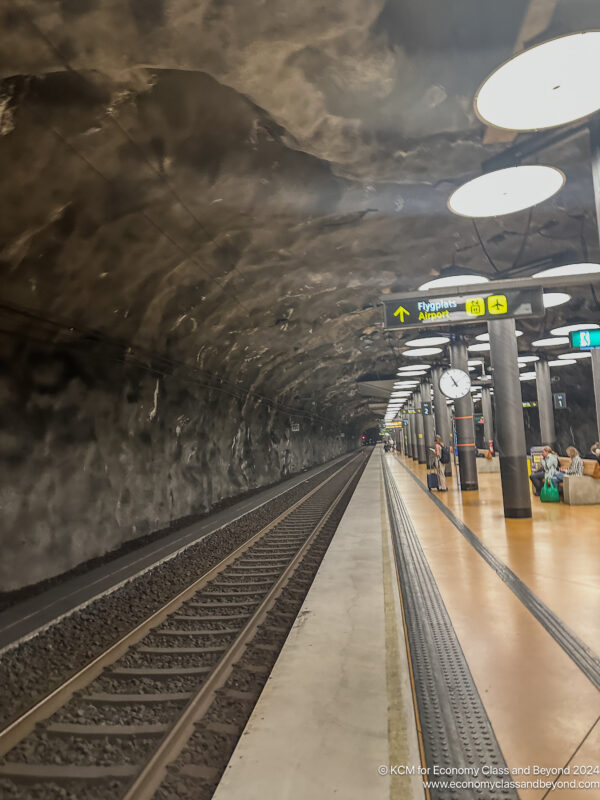 a train station with people waiting