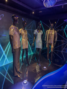 a group of mannequins in a room with blue lights