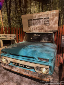 a blue truck with a camper on top