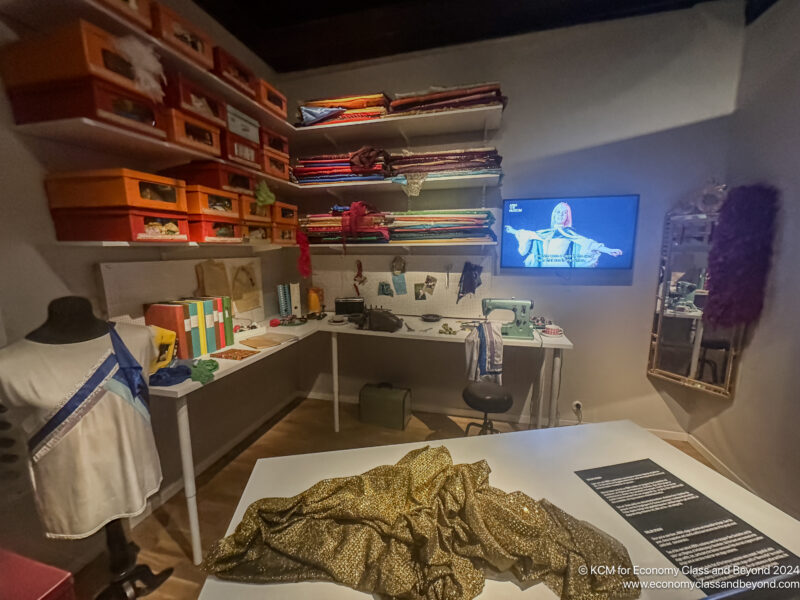 a room with a table and shelves and a television