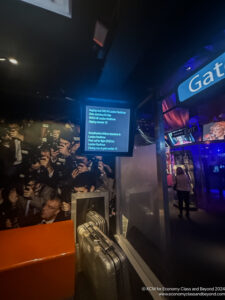 a screen with a blue screen and a crowd of people in the background