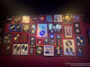 a wall with many framed records