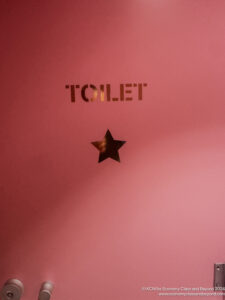 a pink sign with a star on it