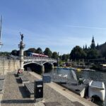 a bridge over a river with a statue and boats