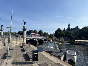 a bridge over a river with a statue and boats