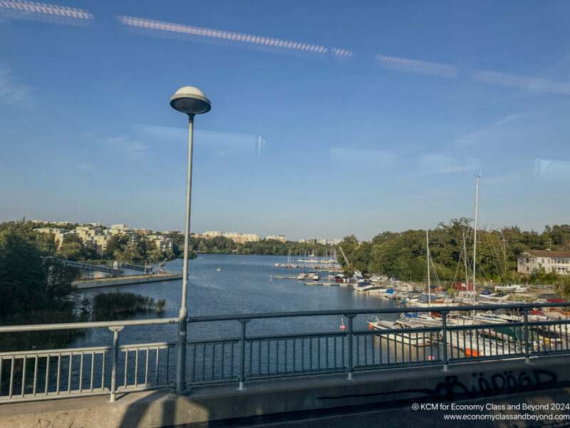 a bridge over a body of water with boats and a city in the background