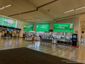 a large airport terminal with green signs