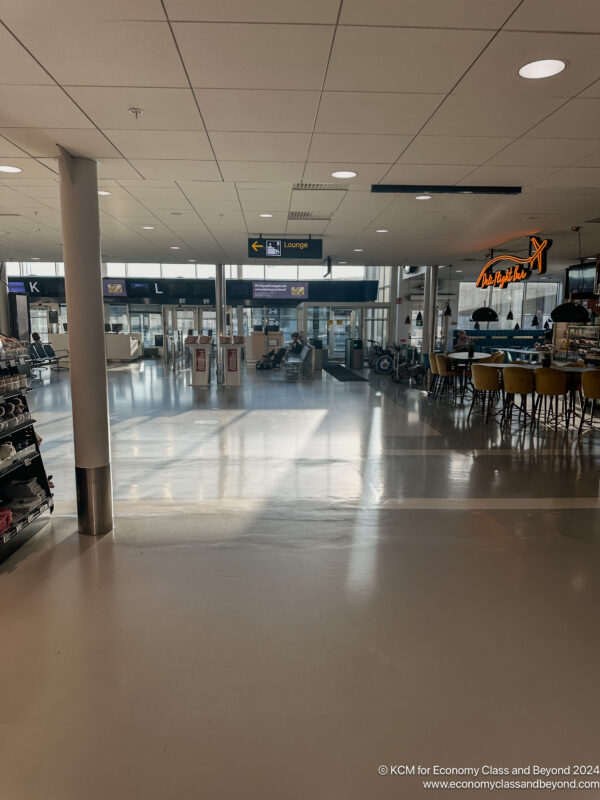 a large airport terminal with tables and chairs