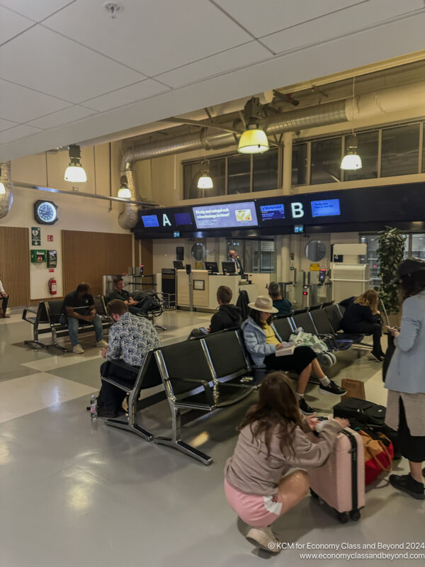 a group of people sitting in a waiting area