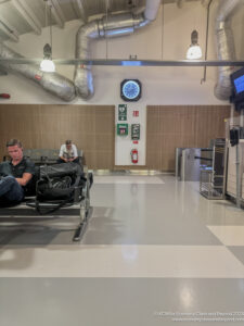 a man sitting on a bench in a airport