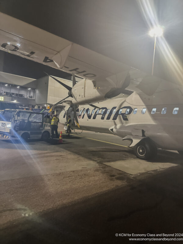 a large airplane with people around it