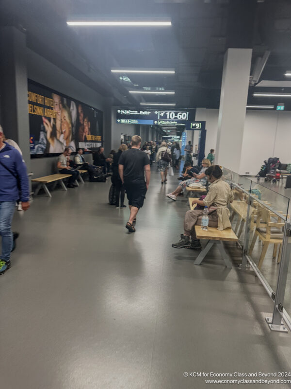 people sitting on benches in a building