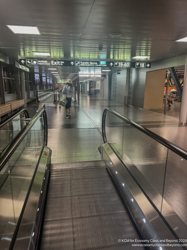 a person walking down an escalator