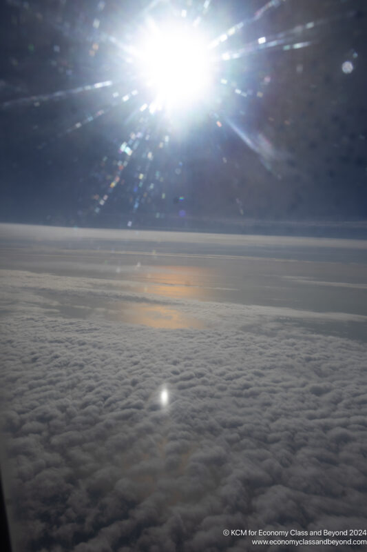 a sun shining through clouds