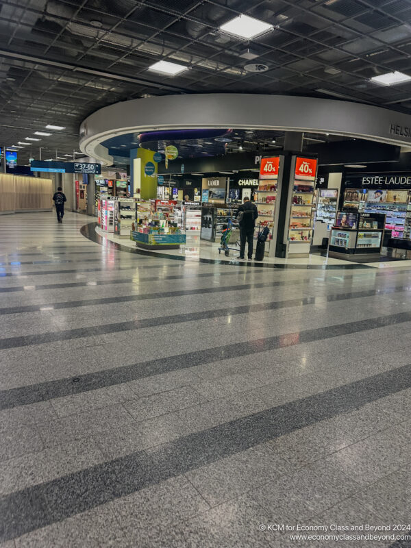 a large airport terminal with people walking