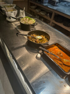 a row of pans with food in them