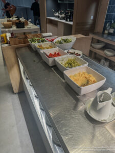 a row of bowls of food on a counter