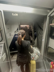 a woman carrying a bag in a vehicle