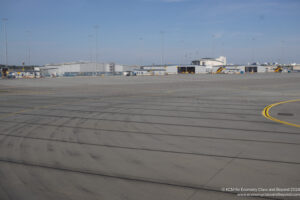 a large empty airport with buildings in the background