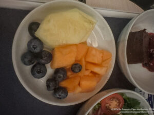 a plate of fruit and a salad