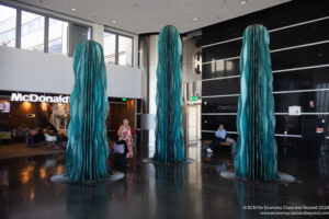 a group of tall blue sculptures in a lobby
