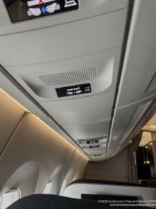 a sign on the ceiling of an airplane