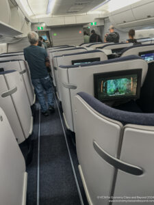a group of people standing in an airplane