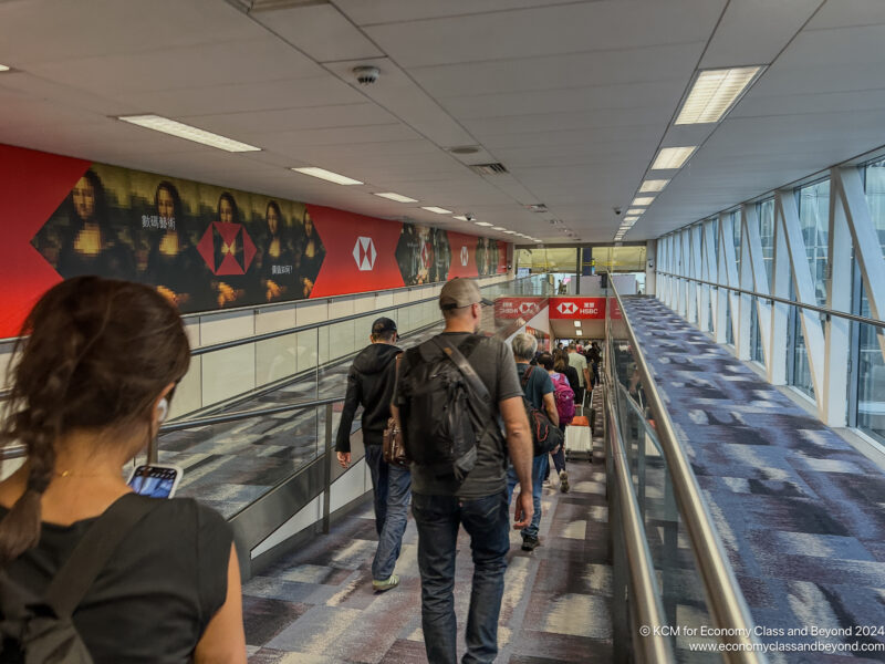 a group of people walking down a walkway