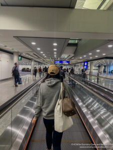 a woman walking on an escalator in an airport