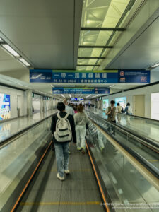 people walking on an escalator in a building