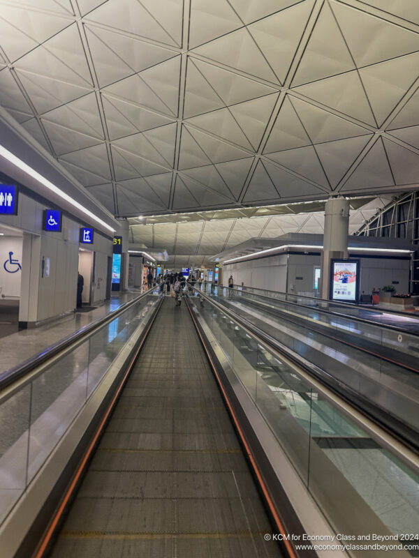 a group of people walking on an escalator