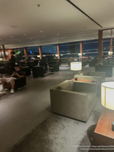 a room with a large window and a couple of people sitting on chairs