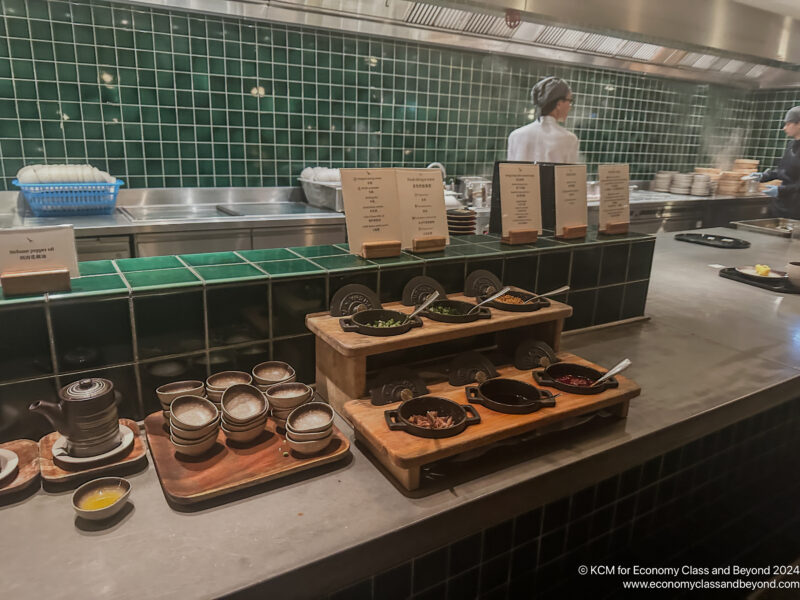 a kitchen with a chef in the background