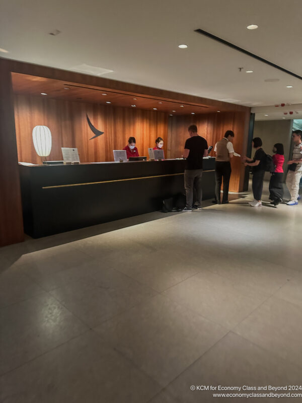 a group of people standing in front of a reception desk