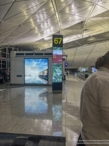 a man standing in a hall with a sign