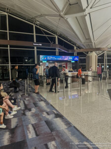 people standing in a line at an airport