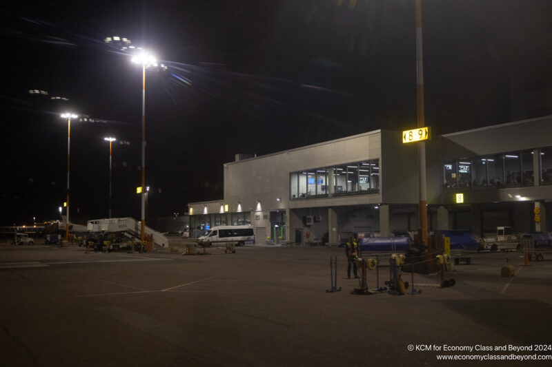 a building with lights and a lot of cars