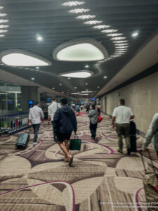 a group of people walking in a hallway