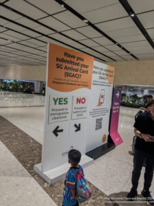 a group of people standing in a hall with signs