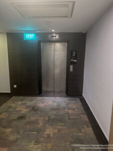 an elevator with a green sign