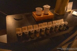 a row of small glass containers with different spices on a table