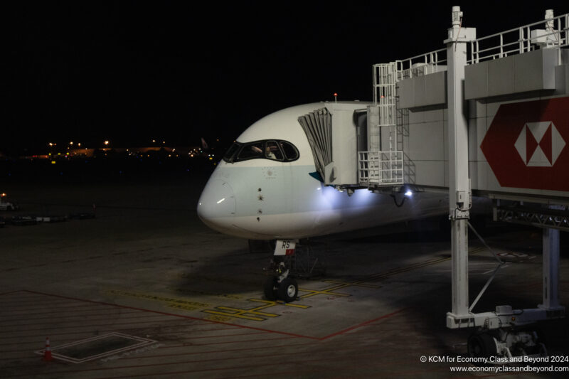 a plane at night with a bridge